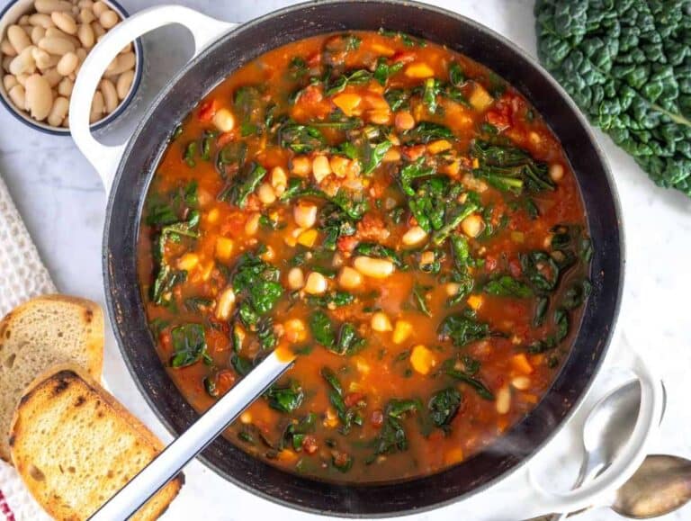 Step 3 Chopped kale added to simmering Mediterranean kale soup until tender and vibrant.