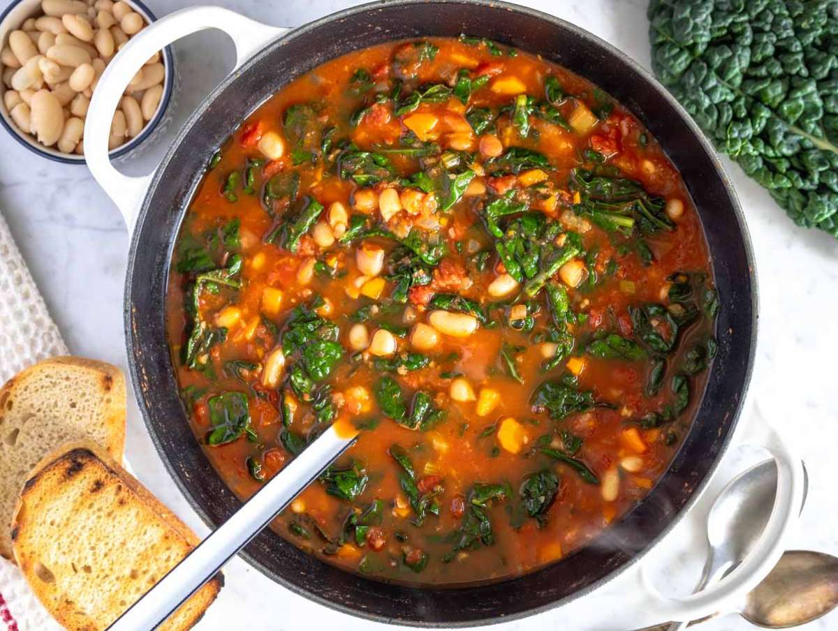 Step 3 Chopped kale added to simmering Mediterranean kale soup until tender and vibrant.