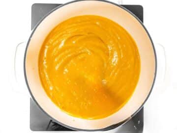 Step 3 Creamy Mediterranean pumpkin soup simmering gently in a large pot.