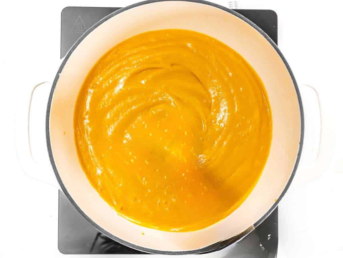 Step 3 Creamy Mediterranean pumpkin soup simmering gently in a large pot.