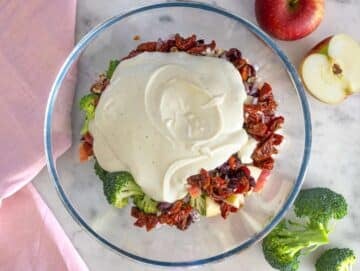 Step 3 Pouring creamy yogurt dressing over colorful salad ingredients.