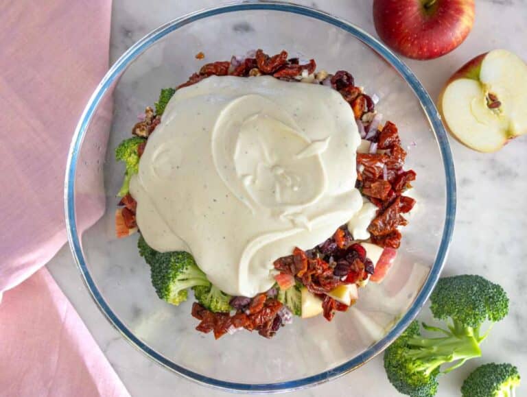 Step 3 Pouring creamy yogurt dressing over colorful salad ingredients.