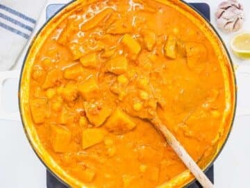 Step 3 Squash chickpeas tomatoes and coconut milk simmering together for butternut squash chickpea curry.