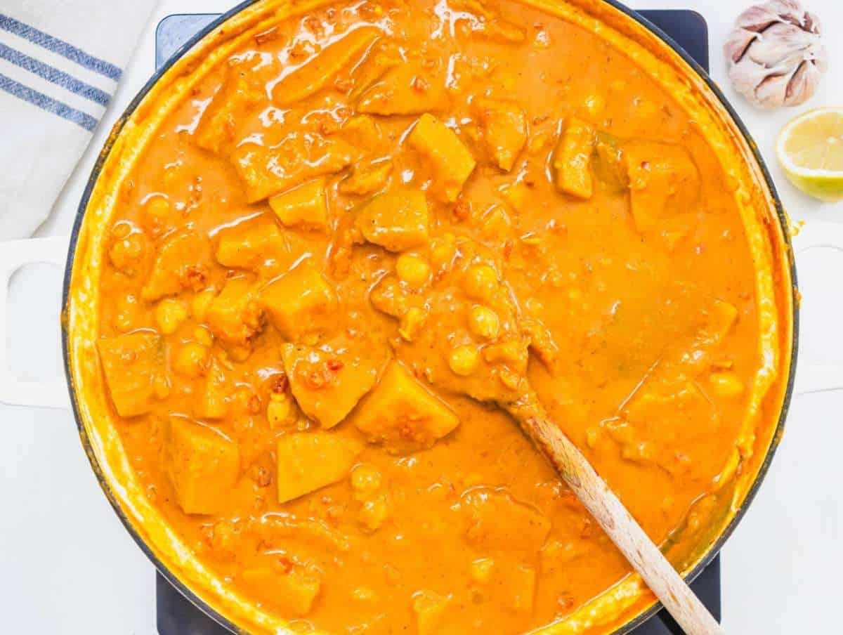 Step 3 Squash chickpeas tomatoes and coconut milk simmering together for butternut squash chickpea curry.