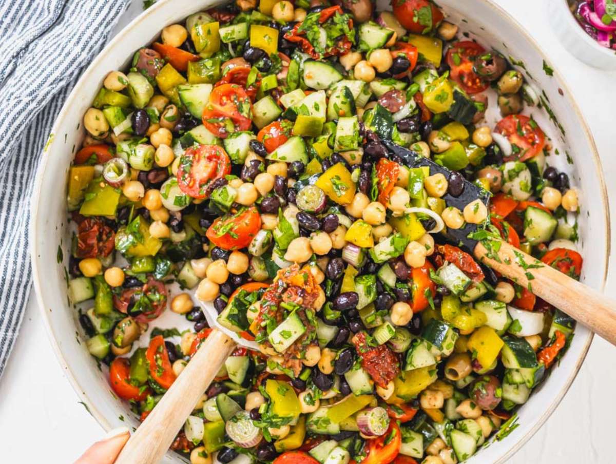 Step 3 Tossing beans and chopped vegetables together in a large bowl before serving.