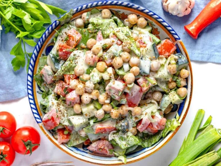 Step 3 Tossing chickpeas and vegetables with creamy tahini dressing until evenly coated.