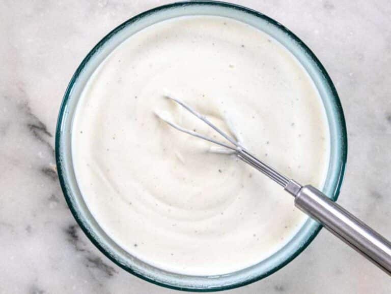 Step 3 Whisking Greek yogurt dressing with mustard honey and vinegar in a small bowl.