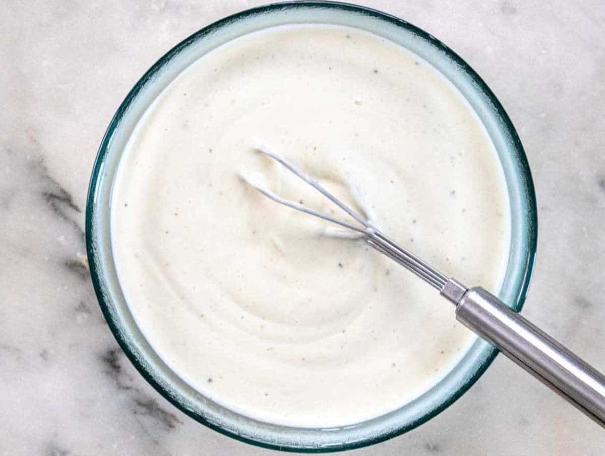 Step 3 Whisking Greek yogurt dressing with mustard honey and vinegar in a small bowl.
