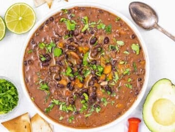 Step 4 Finished black bean soup served with cilantro lime and avocado slices.