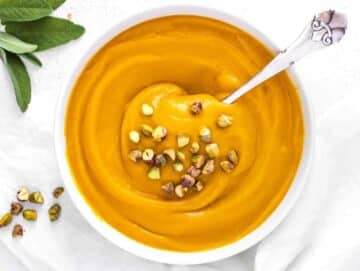 Step 4 Mediterranean pumpkin soup served hot with crunchy toppings and fresh herbs.