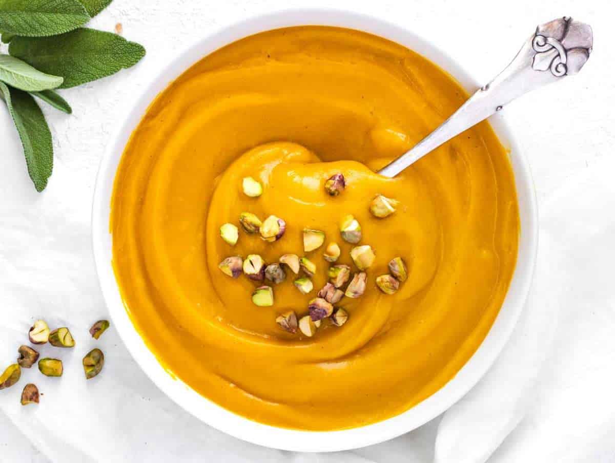 Step 4 Mediterranean pumpkin soup served hot with crunchy toppings and fresh herbs.