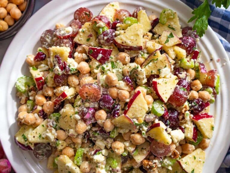 Step 4 Serving colorful chickpea cranberry salad on platter with feta and herbs.