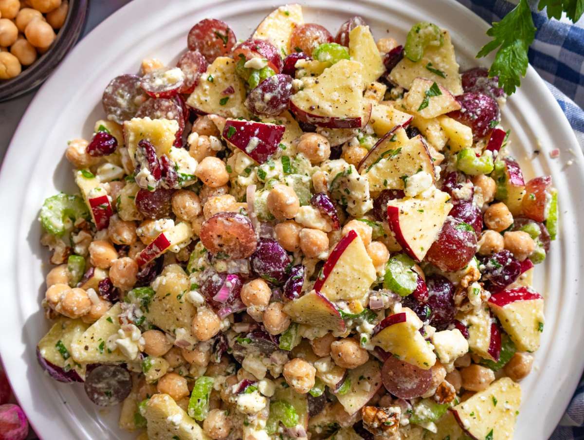Step 4 Serving colorful chickpea cranberry salad on platter with feta and herbs.