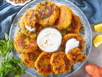 Step 4 – Serving chickpea sweet potato fritters with yogurt sauce and a squeeze of lemon.