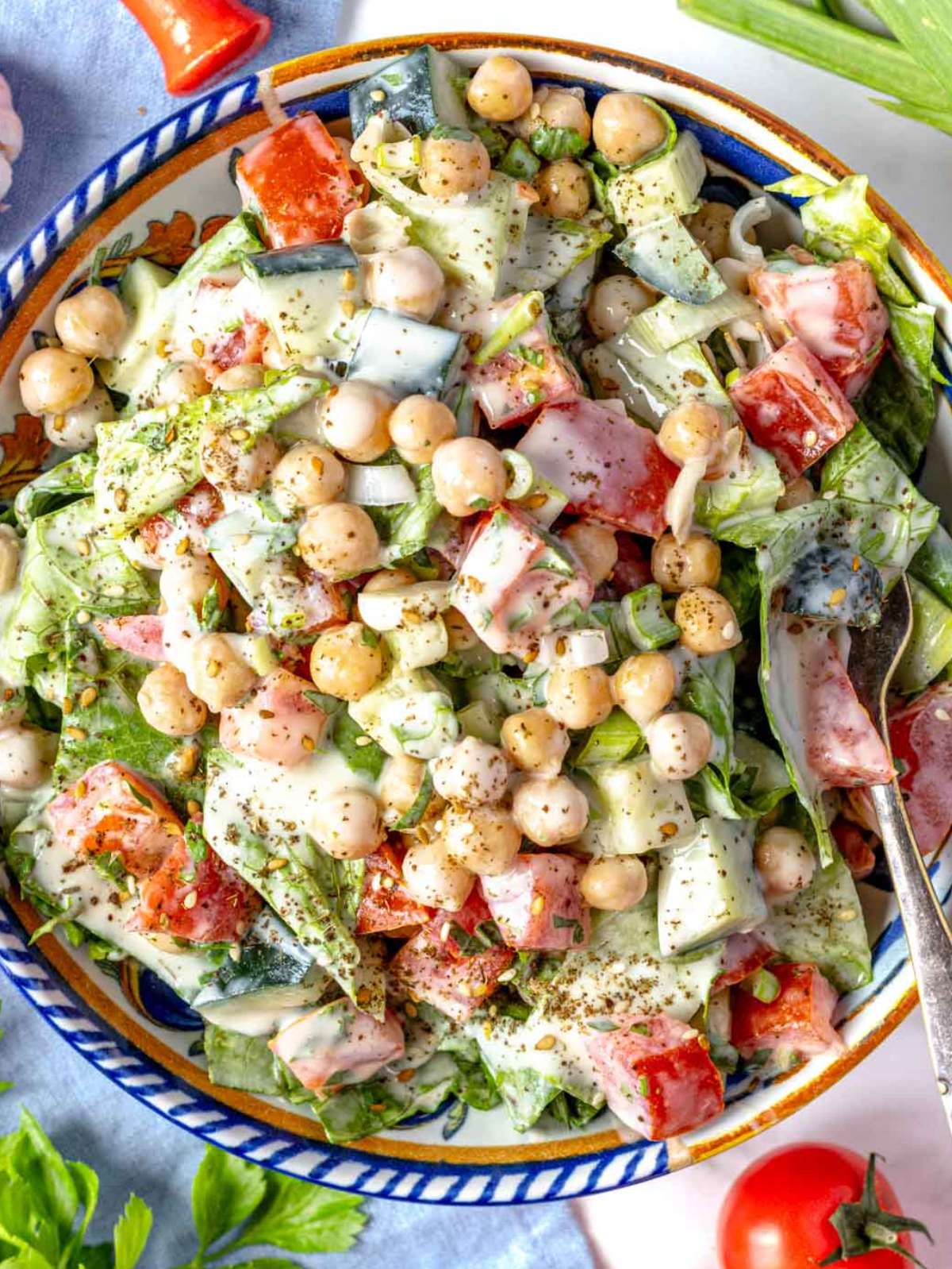 Top down view of colorful chopped chickpea salad in a colorful mediterranean bowl.