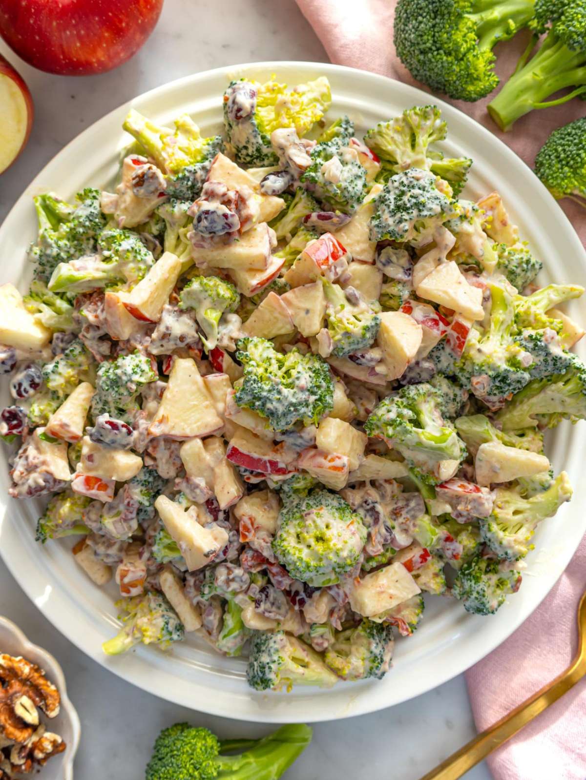 Top down view of colorful cranberry broccoli salad with apples and sun-dried tomatoes.