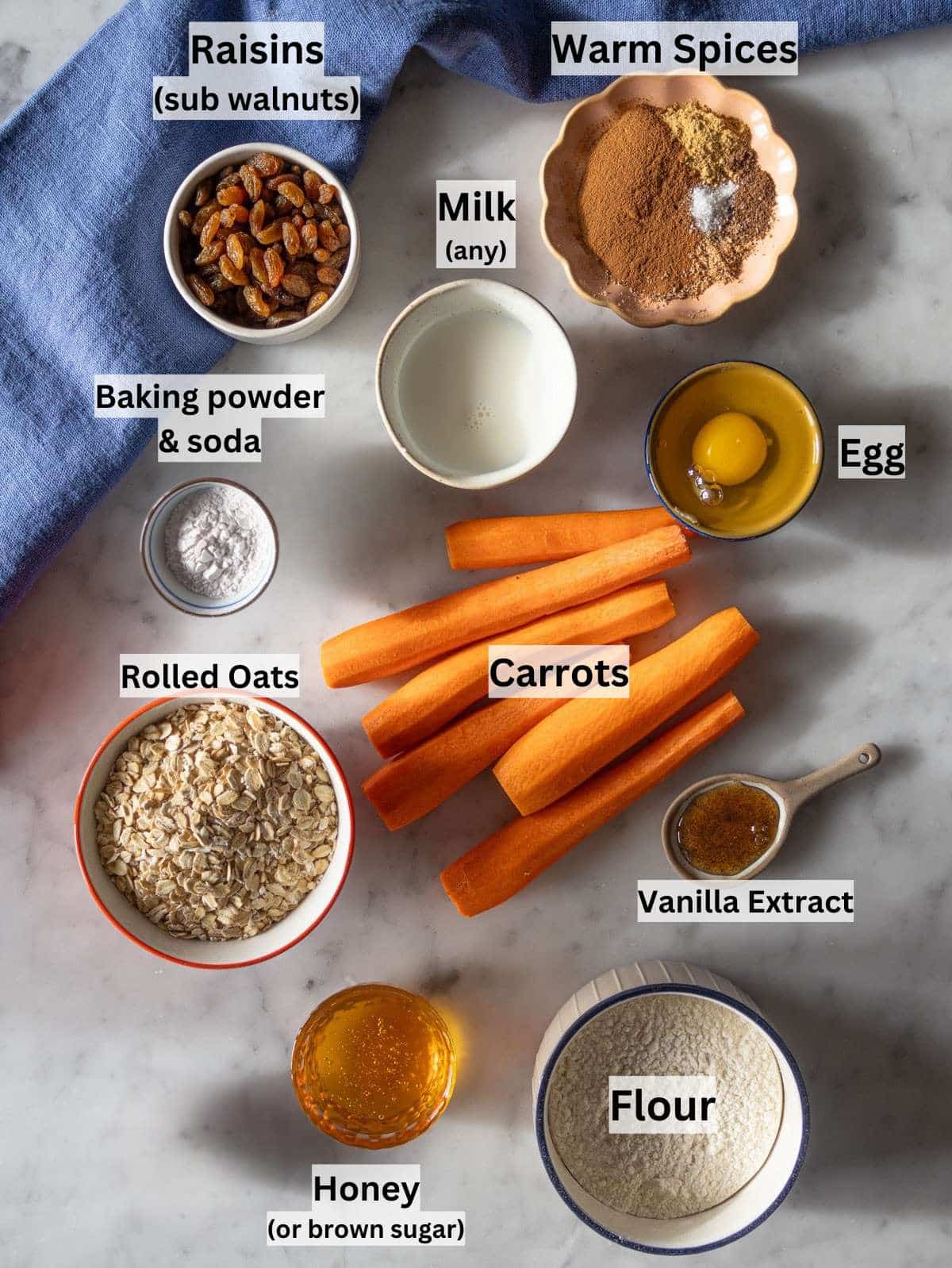 Carrot cake muffin ingredients arranged neatly on a kitchen counter.