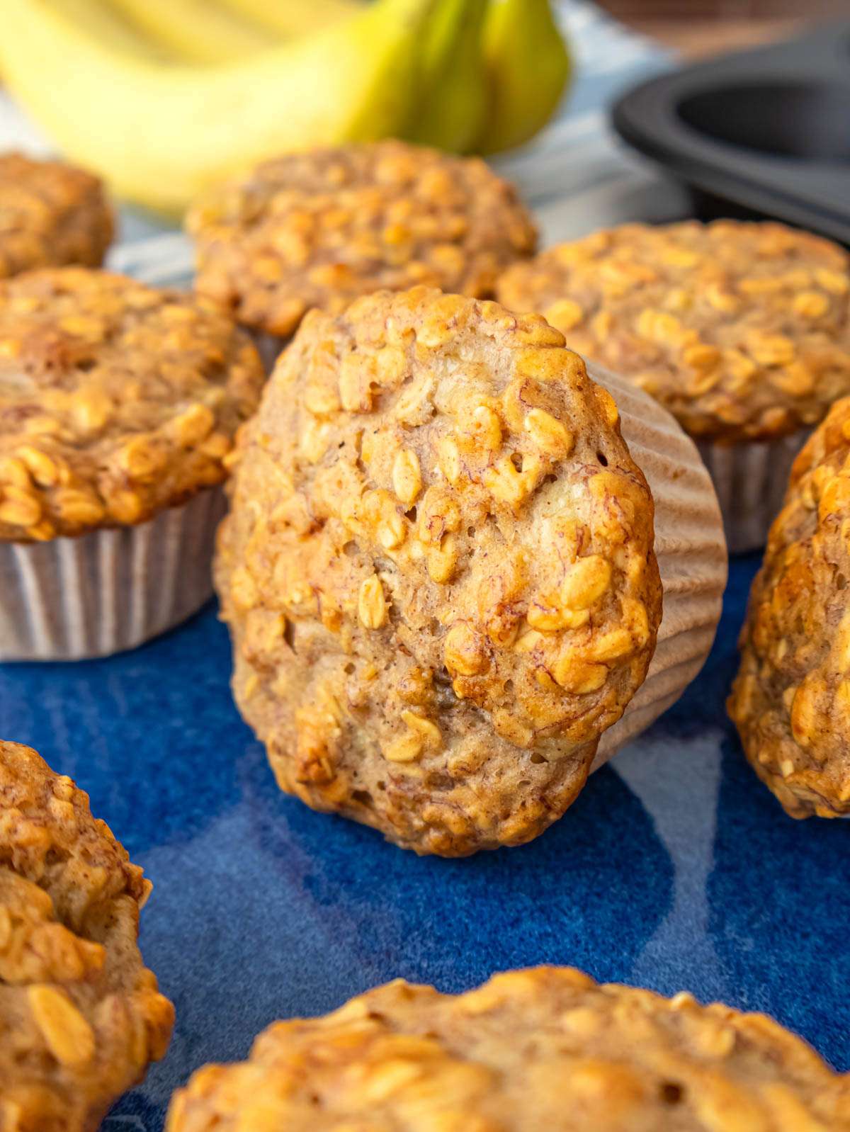 Close up of soft banana oatmeal muffins with golden oats on top.