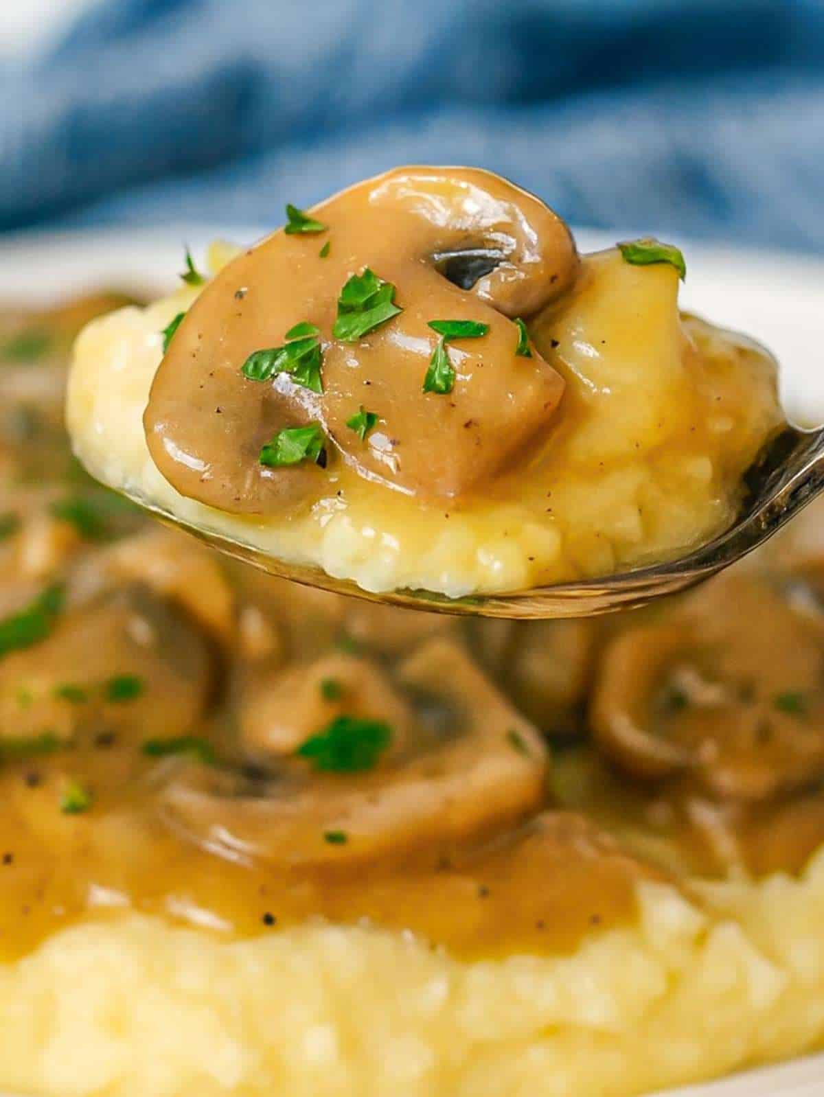 Creamy mushroom sauce drizzled over a spoonful of mashed potatoes.