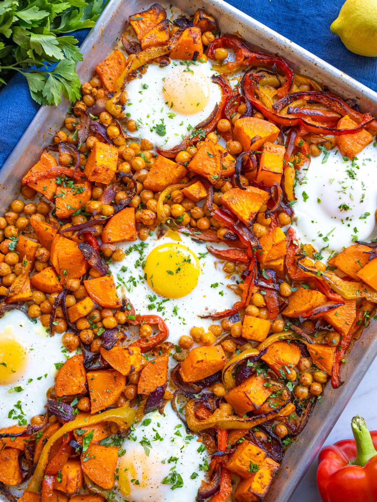 Finished dish top down healthy sheet pan eggs and veggies with sweet potatoes and chickpeas.
