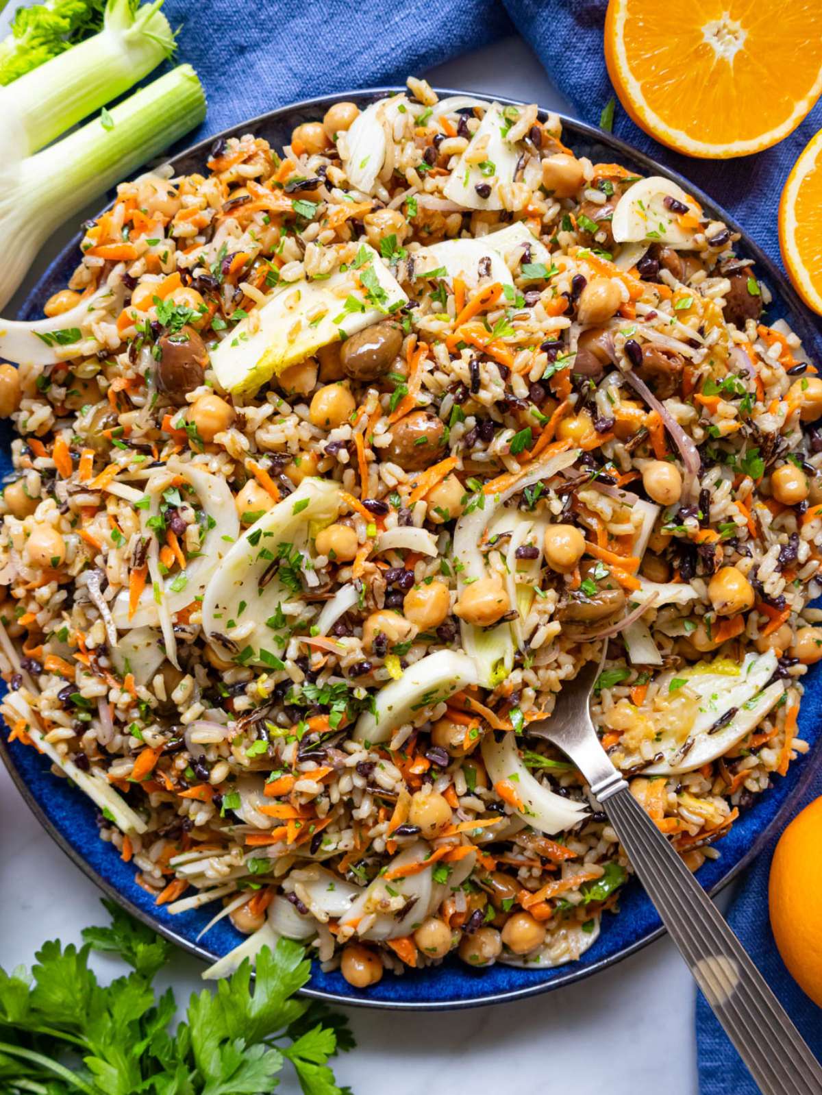 Finished salad top down Mediterranean wild rice salad in large bowl with olives.