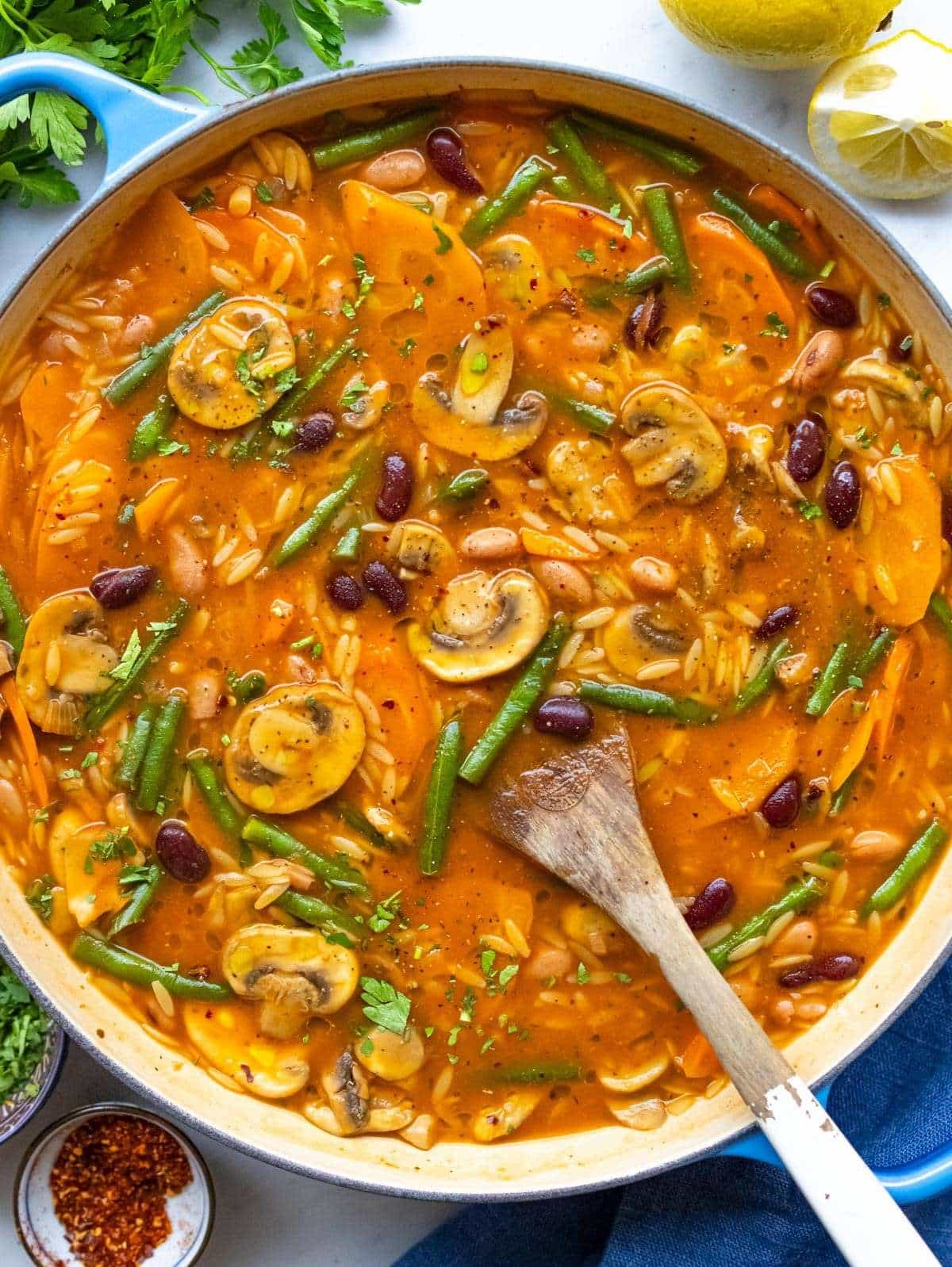 Finished soup top down hearty three bean orzo soup in a pot.