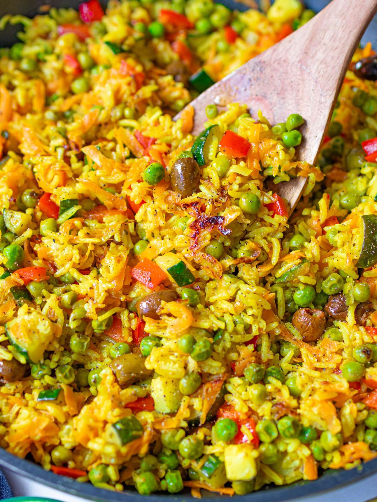 Golden veggie skillet with peas zucchini carrots and Mediterranean stir fried rice.