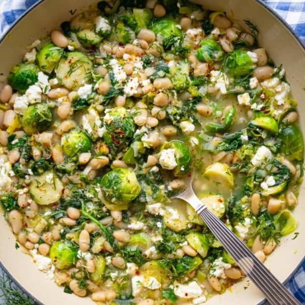 Greek-inspired Mediterranean greens and beans in skillet ready to serve.