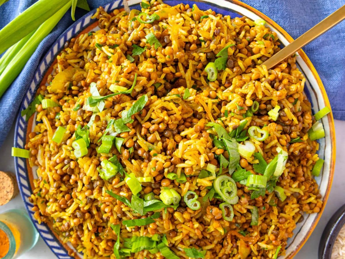 Healthy Mediterranean lentils and rice with fresh herbs and a squeeze of lemon on top.