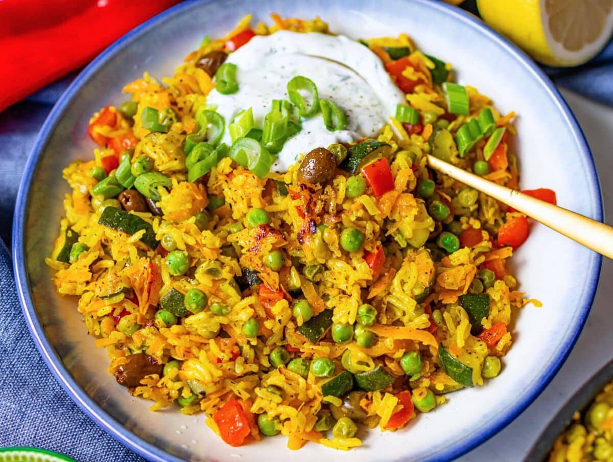 Healthy Mediterranean stir fry dinner with bright golden stir fry and fresh toppings.