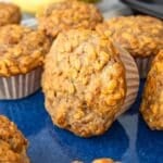 Healthy banana oatmeal muffins made with oats and Greek yogurt on a blue platter.