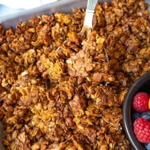 Healthy granola recipe with big crunchy clusters styled for a clean Mediterranean diet friendly breakfast.