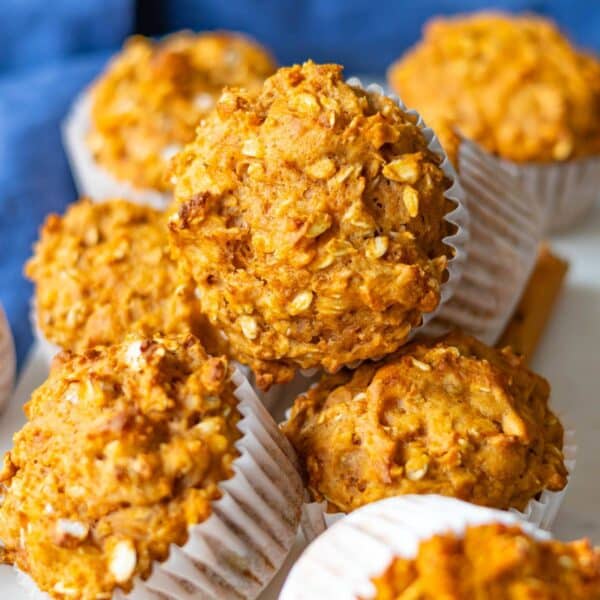 Healthy sweet potato oatmeal muffins stacked for an easy oil free breakfast.