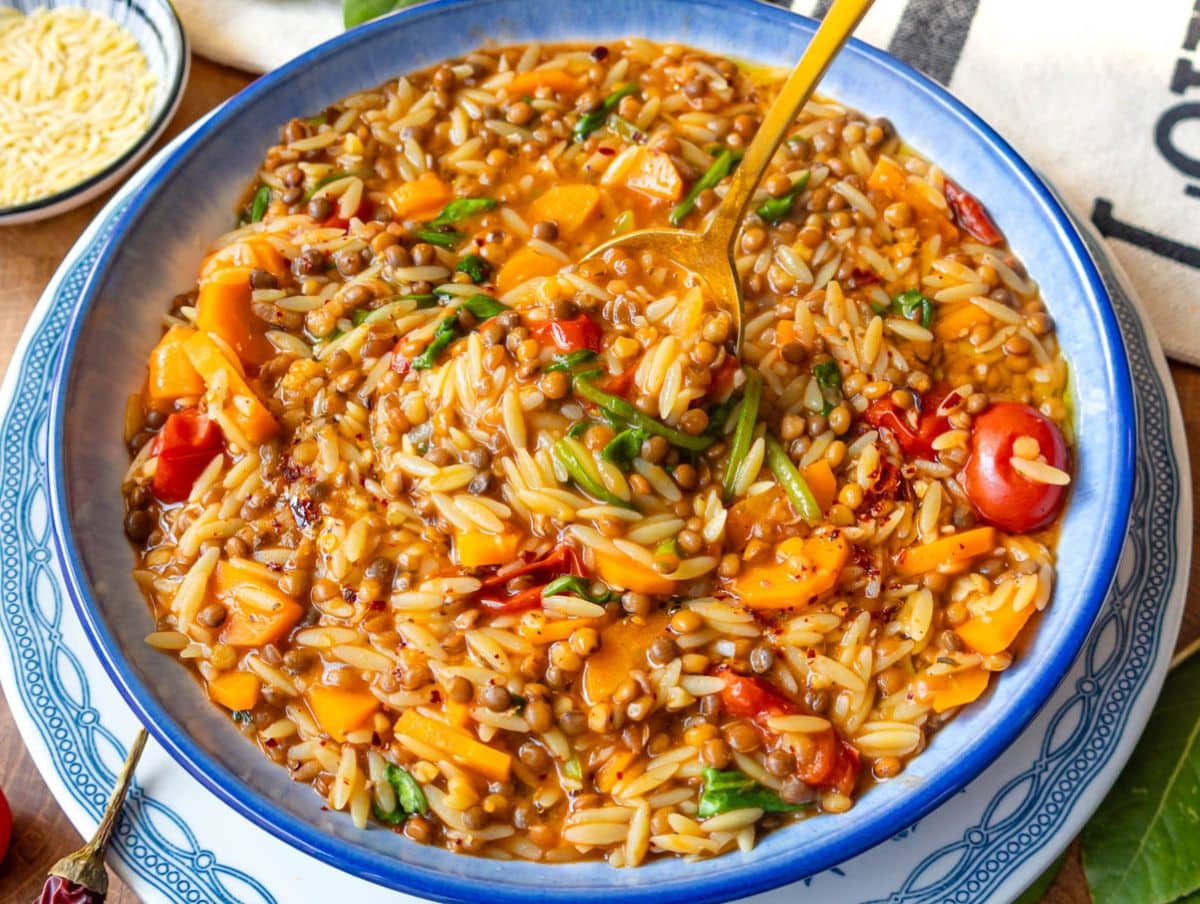Hearty lentil and orzo meal in a white and blue bowl perfect for a quick weeknight dinner.