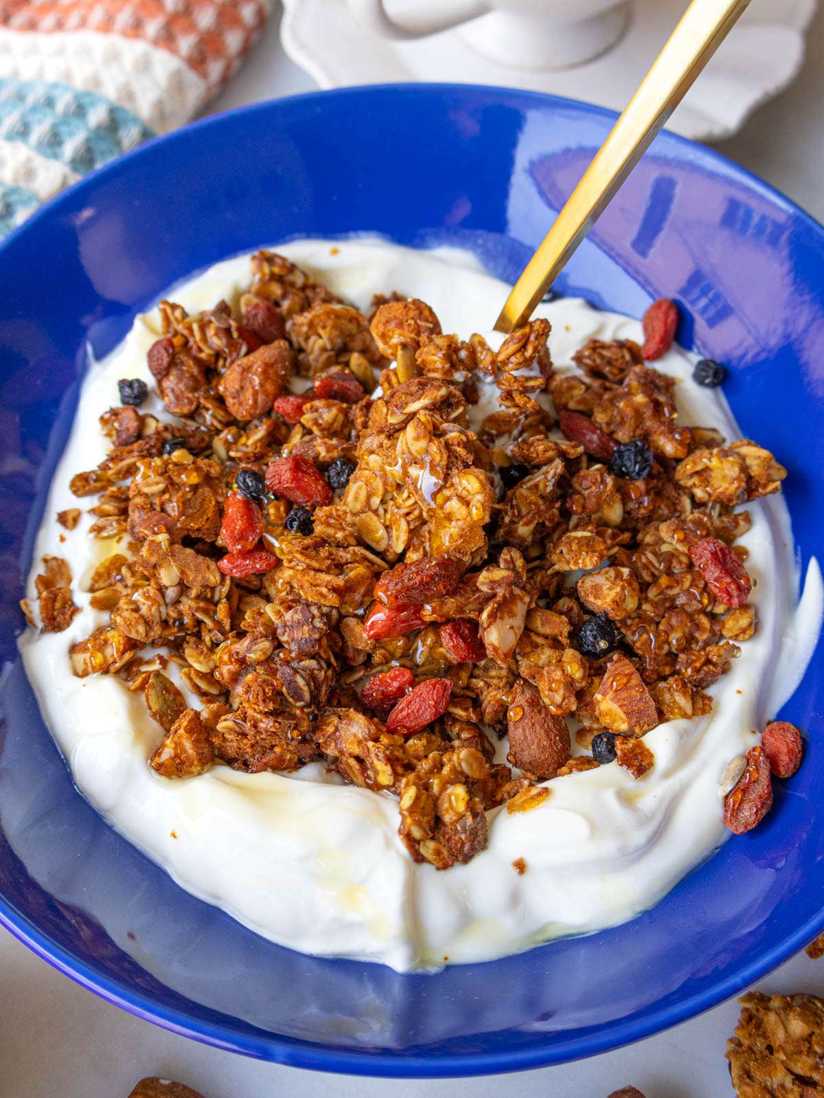 Homemade healthy granola made without oil served on Greek yogurt for a nutritious breakfast.