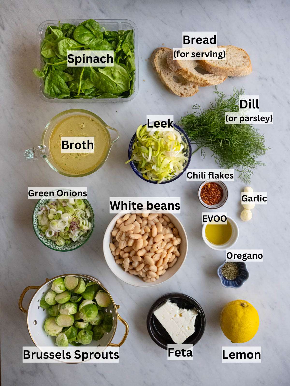 Ingredients arranged for Mediterranean greens and beans with spinach Brussels sprouts and leeks.