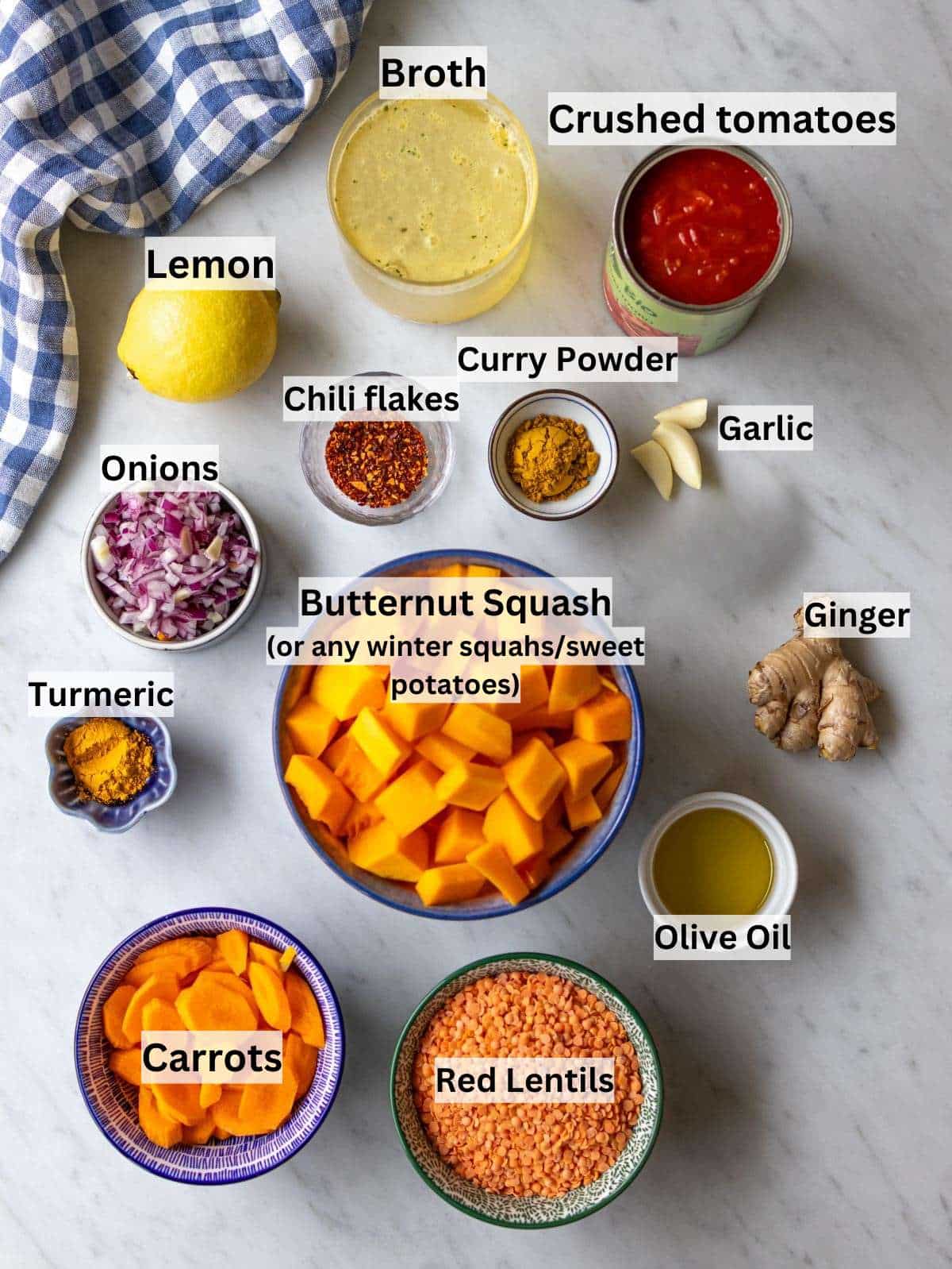 Ingredients arranged for curried red lentil soup with veggies lentils and spices.