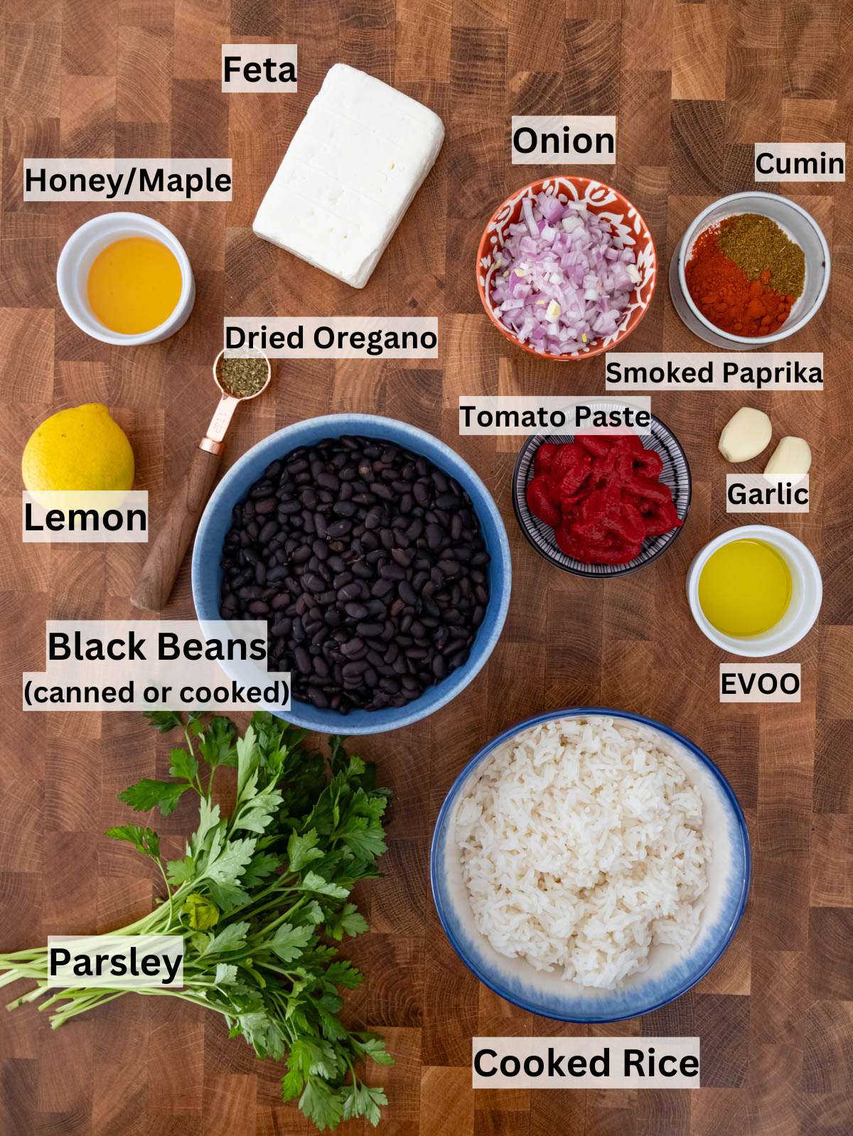 Ingredients for black beans and rice including black beans rice onion tomato paste spices and feta.
