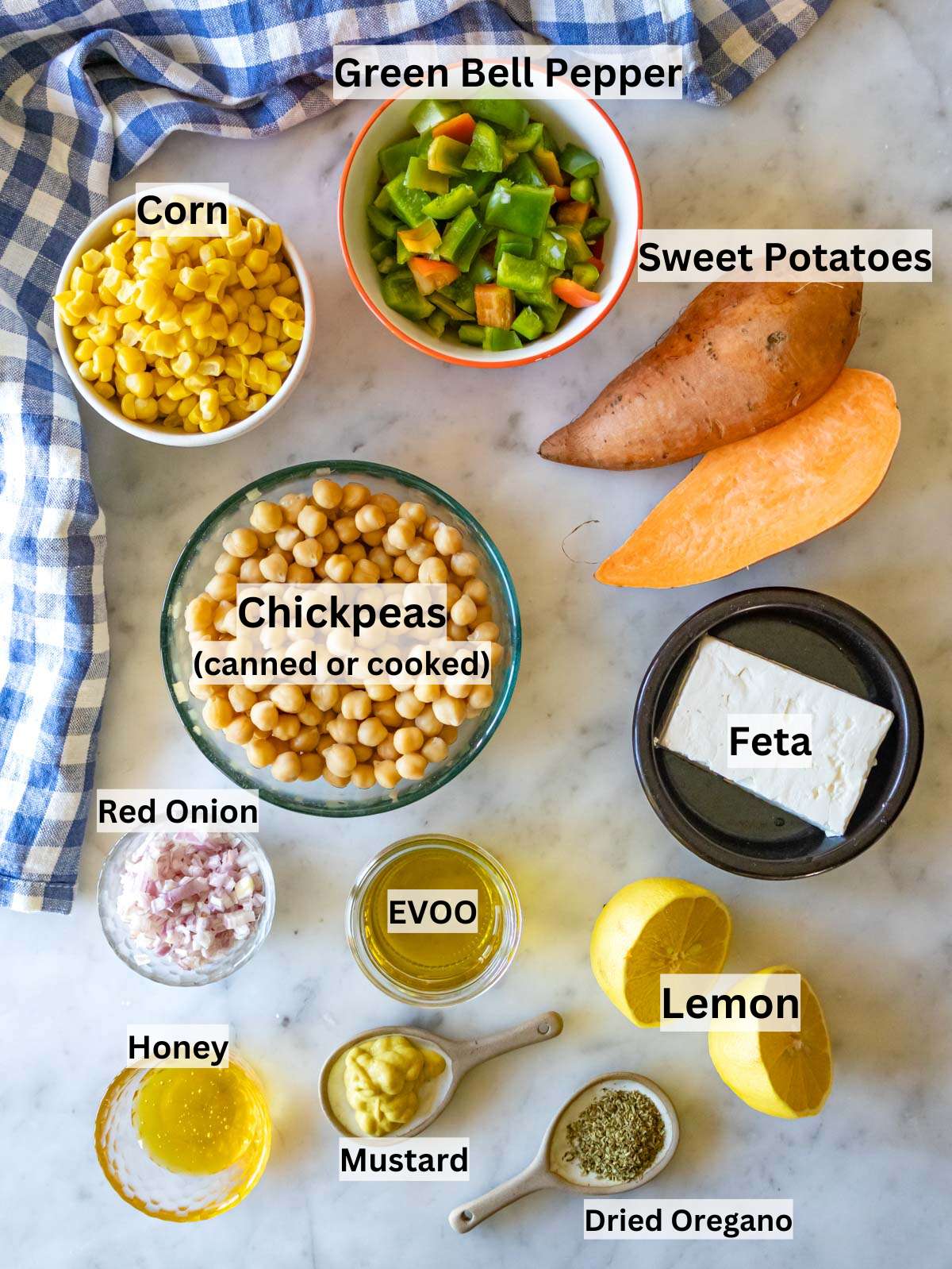 Ingredients for chickpea sweet potato salad with bell pepper corn feta onion and honey mustard dressing.