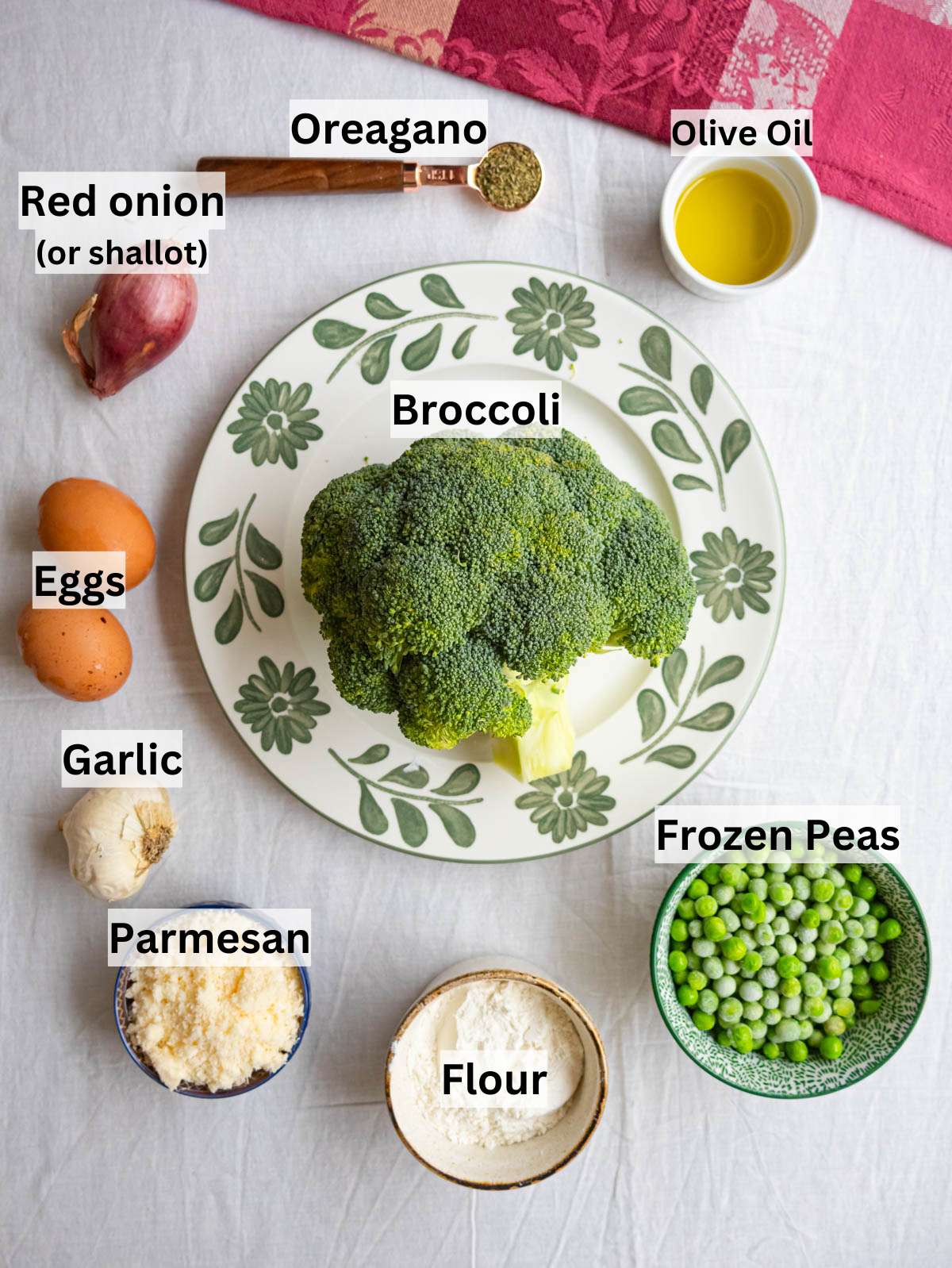 Ingredients picture — broccoli peas eggs and parmesan arranged on a table ready to cook.