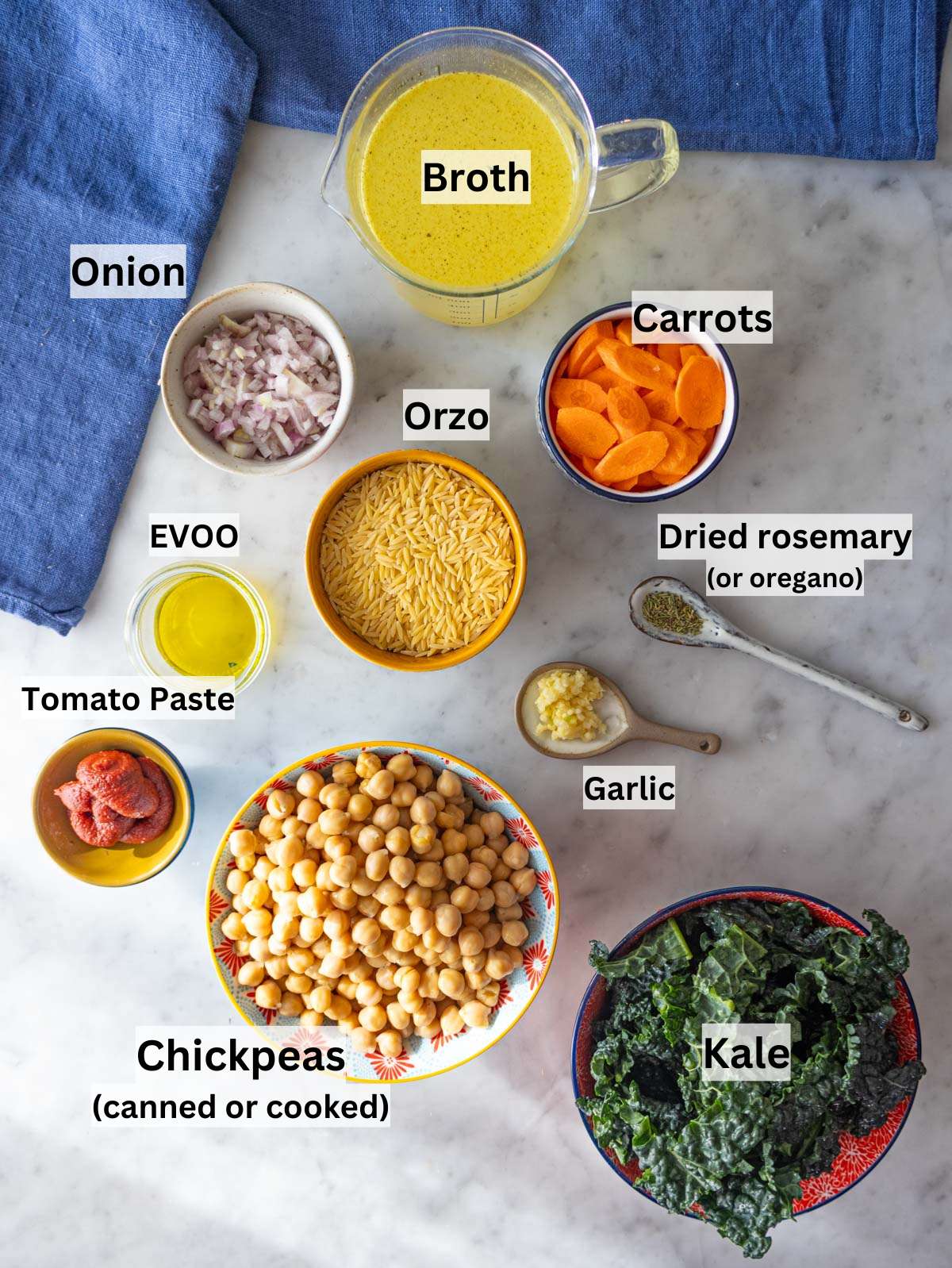 Mediterranean chickpea and orzo ingredients on a marble table ready to cook.