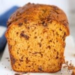 Sliced sweet potato bread with dark chocolate chunks showing moist texture and warm golden crumb.