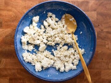 Step 1 Crumbled feta mixed with lemon juice honey and oregano for tangy Mediterranean topping.