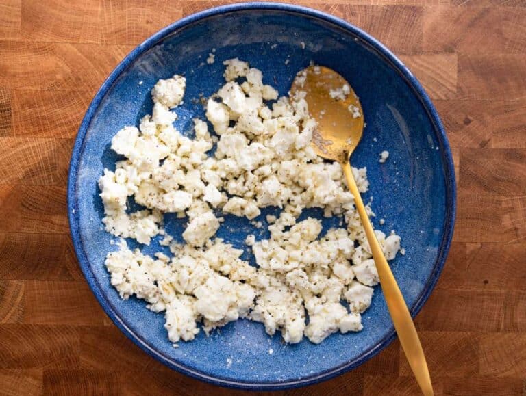 Step 1 Crumbled feta mixed with lemon juice honey and oregano for tangy Mediterranean topping.