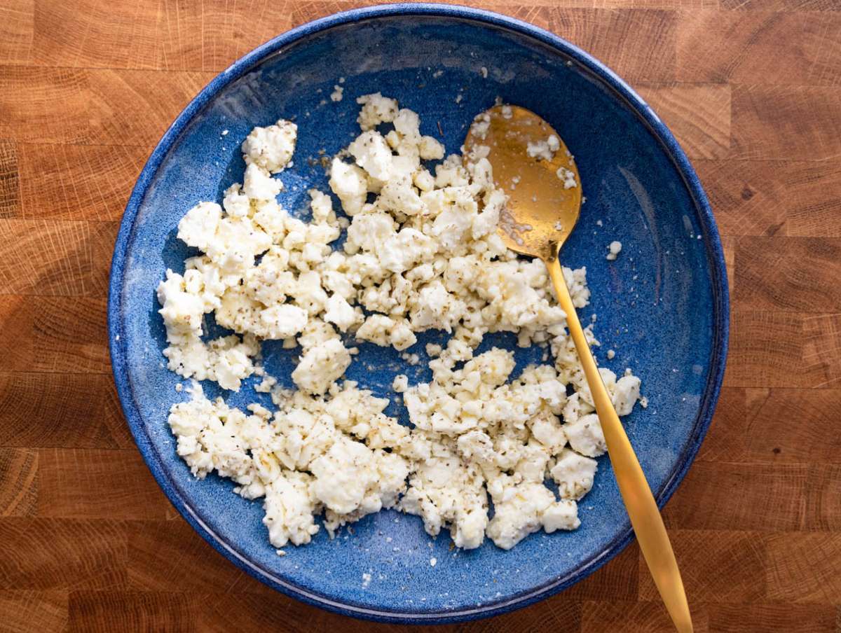 Step 1 Crumbled feta mixed with lemon juice honey and oregano for tangy Mediterranean topping.