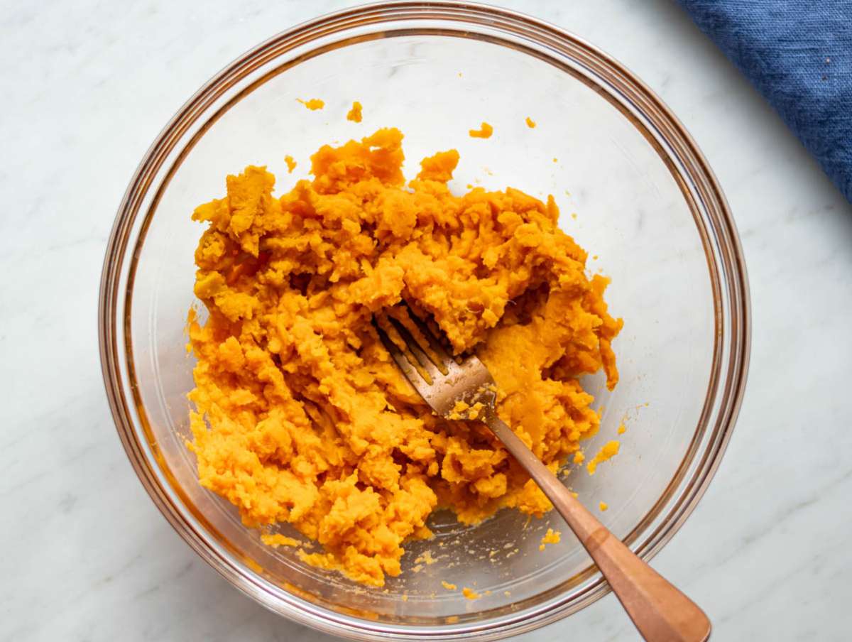 Step 1 Mashed sweet potatoes in a bowl ready for baking sweet potato oat muffins.