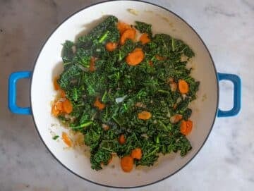 Step 1 Sautéing onion carrots and kale in olive oil for chickpea orzo.