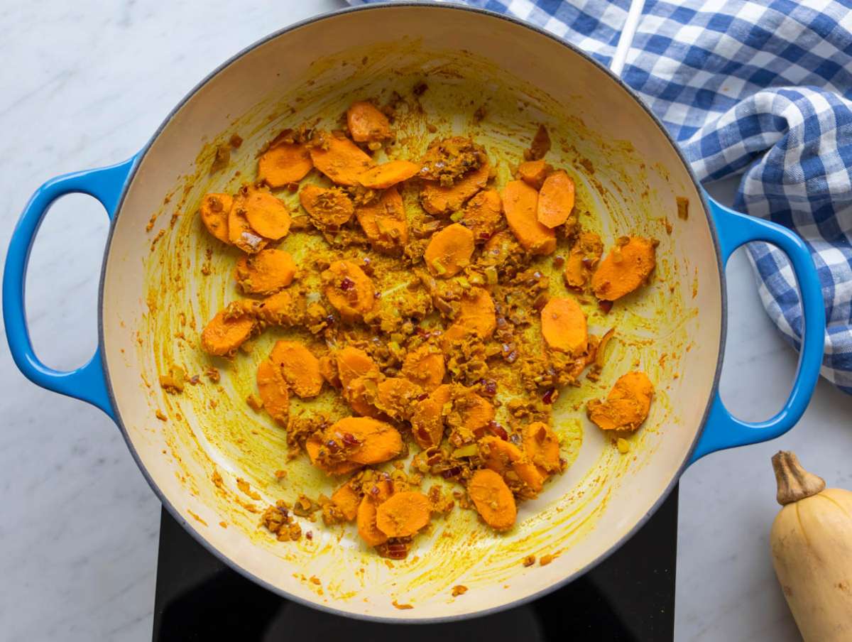 Step 1 Sautéing onion carrots garlic and spices to start curried red lentil soup.