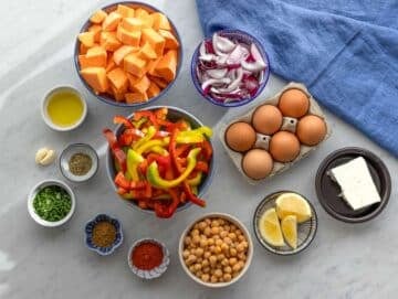 Step 1 Step prep sweet potatoes peppers onions and chickpeas chopped for sheet pan dinner.