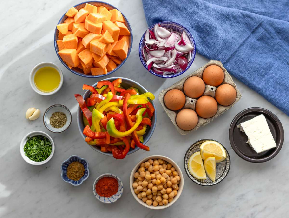 Step 1 Step prep sweet potatoes peppers onions and chickpeas chopped for sheet pan dinner.